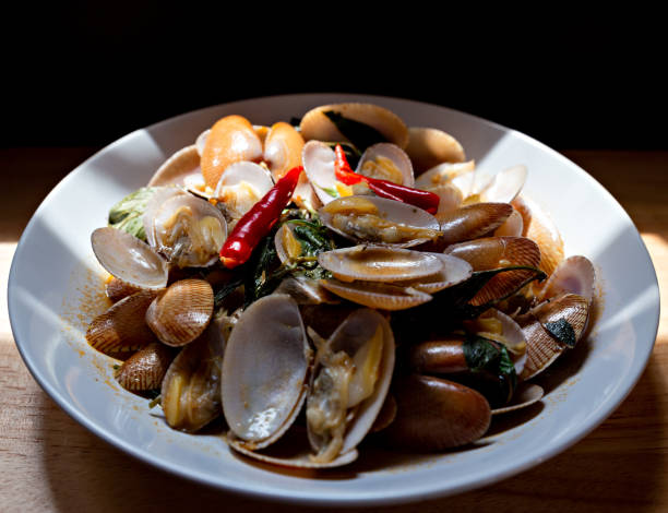 istock Delicious stir fried clams with chili paste on white plate.Thai food. 1220902106