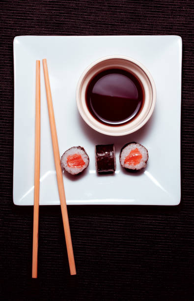 istock Hosomaki_sushi_on_a_square_plate_decorated_with_chopsticks 1220903068