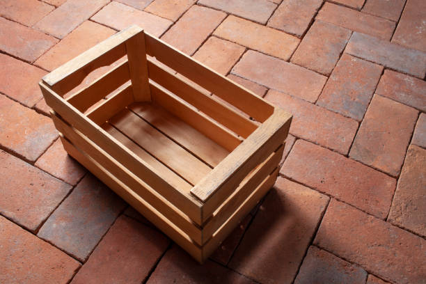 Wooden empty crate Wooden empty crate on old terracotta floor. farm produce storage stock pictures, royalty-free photos & images
