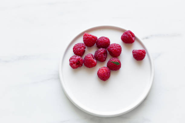 Fresh raspberries and green leaves