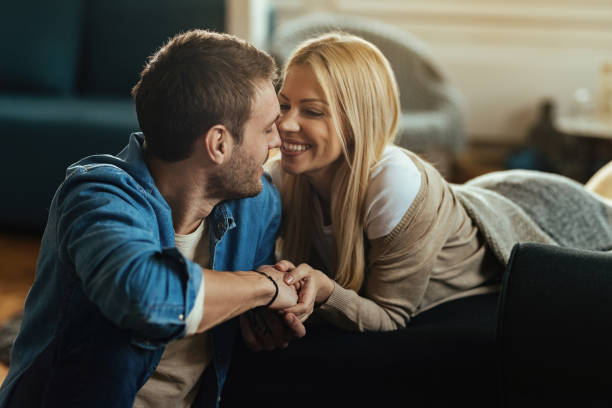 istock Loving couple holding hands and talking at home. 1220908365