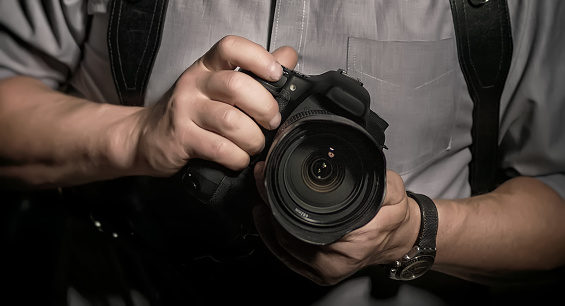 Man's hands holding a camera