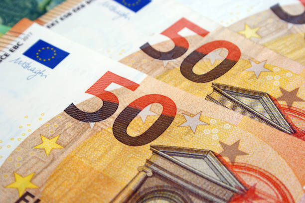 Part of Fifty Euro banknote. Euro currency in Europe. Financial colorful background. Concept of printing money from the European mint and the European Central Bank ECB