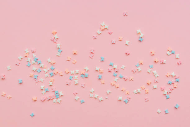 istock sprinkles background, sugar sprinkle butterflies, decoration for cake and bakery. Top view, flat lay. pastel colors. 1220912004