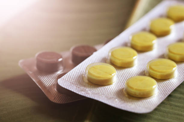 Black and yellow pills so close, sunlight toned