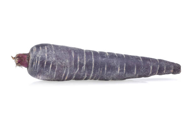 istock purple carrot isolated on white background. 1220914371