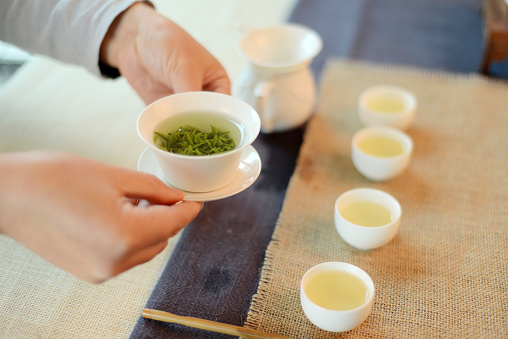 A woman is making green tea
