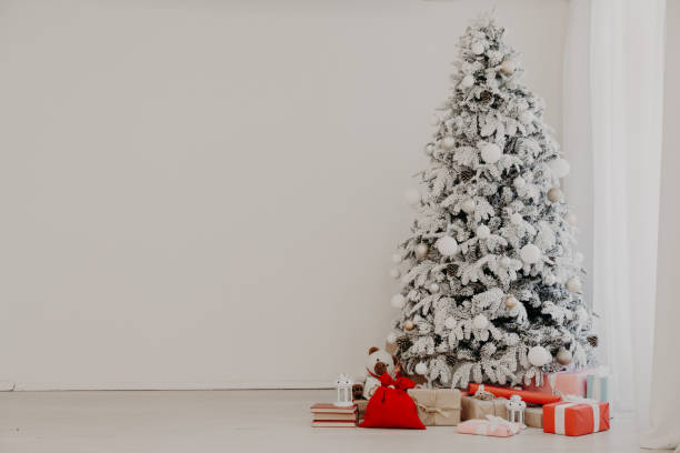 istock new year Christmas tree holiday gifts white interior winter decor 1220919210