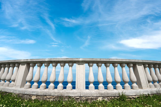 istock White balustrade with seascape and blue sky with clouds 1220920343