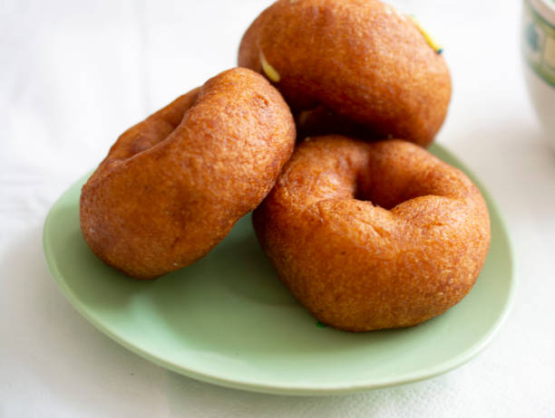 istock Three delicious donuts on a green saucer. 1220920378