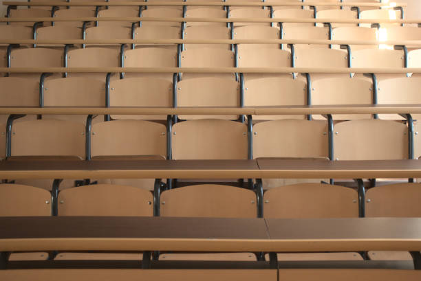 Shot of well organized empty university classroom seats due to global pandemic stock photo
