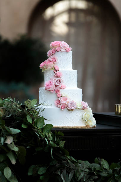 istock Pink and White  tiered wedding cake in an  outdoor setting 1220922474