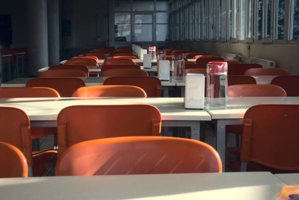 Close up shot of empty seats of a cafeteria after the closing of schools stock photo