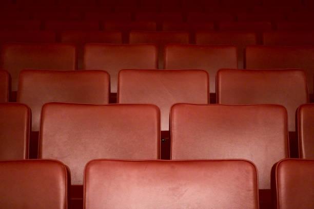 Empty red seats of a theater after the curfew regarding corona virus stock photo