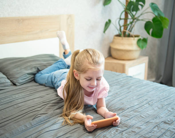 istock Girl playing on smartphone 1220923158