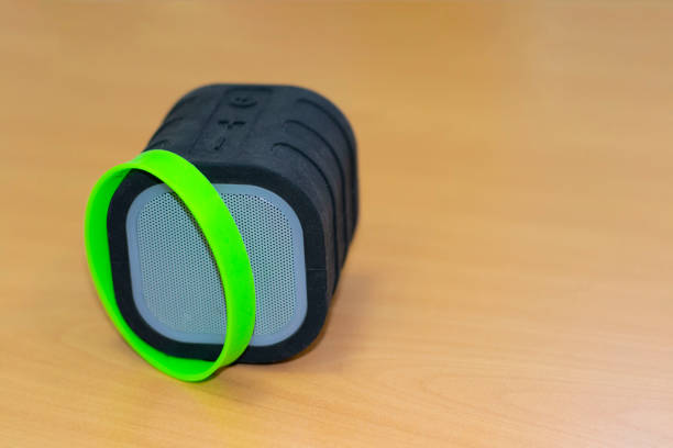 istock Mini speaker black on wooden background. close-up. 1220923649