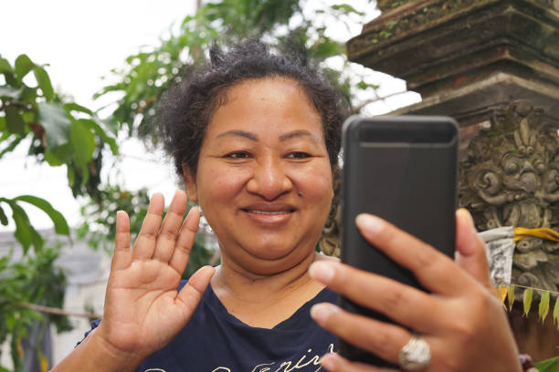 istock Old Southeast Asian Woman Making a Video Call 1220923705