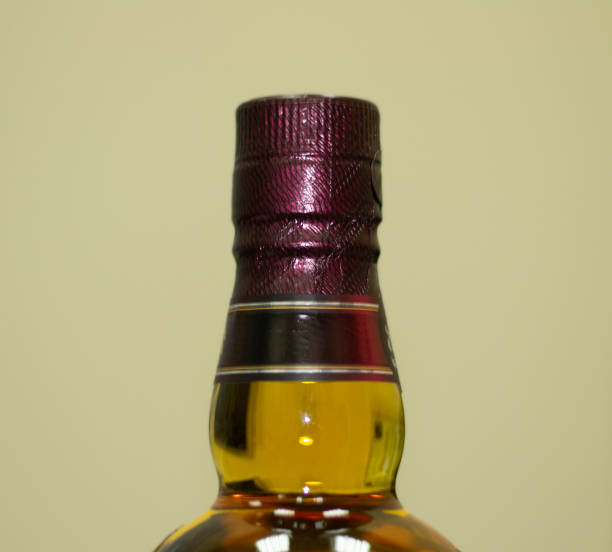 istock neck of Whiskey bottle. grey background. close-up. 1220924671