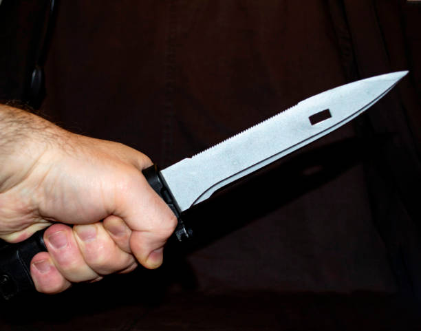 istock bayonet-knife on tactical background. man hand. close-up 1220924685