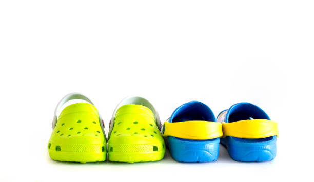 istock on white background children's rubber sandals blue and green. 1220924742