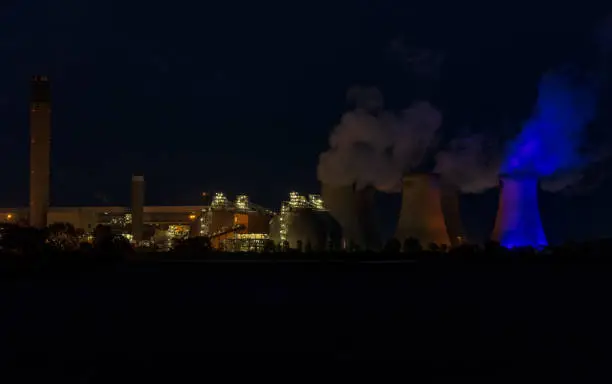 Stunning effect of a blue light on one of the cooling towers of a Power Station near Drax, North Yorkshire in support of Thursday night's Clap for Carers during the Coronavirus pandemic. Night image.