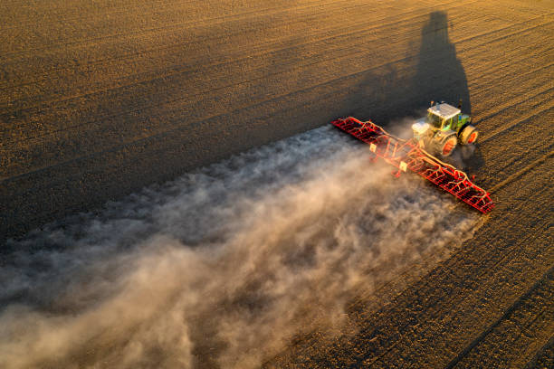 istock Farm Tractor Drilling Seed In Ploughed Field 1220931081