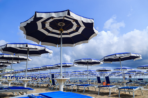 Beach umbrellas and chaise lounges. Rimini, Italy