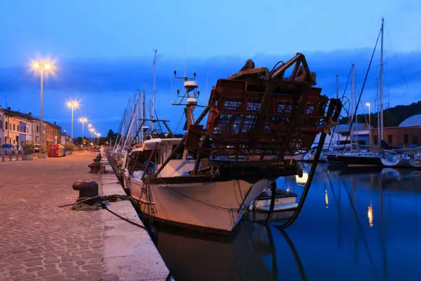 Photo of Harbour in the sunset with fishing boats, yachts. Pesaro, Marche, Italy