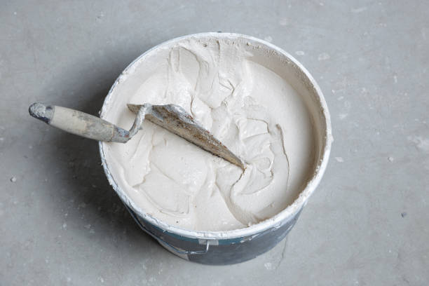 istock Trowel and bucket with fresh mortar 1220935139