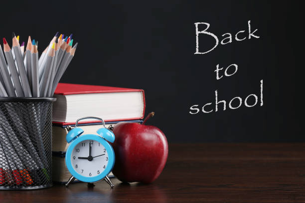 istock Back to school background with book, apple and pencils over blackboard 1220935548
