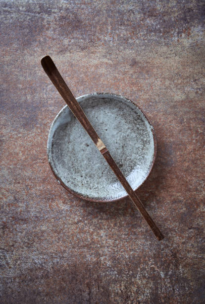 istock Chashaku Matcha spoon and empty ceramics plate on rustic stone background. Symbolic image. Asian culture. Top view. Copy space. 1220935659