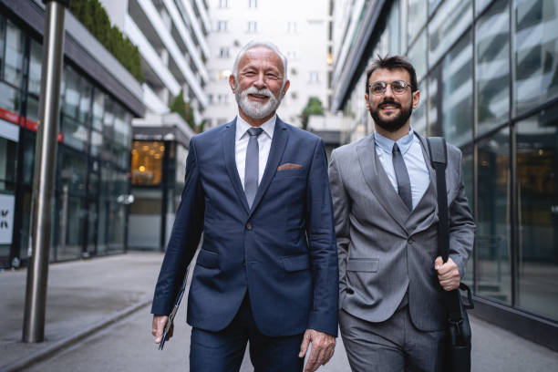istock Two businessmen are walking confidently to the office 1220935679