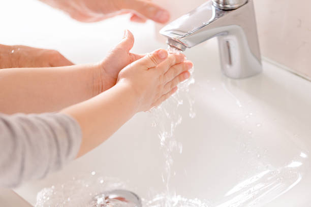 istock A young child washes his hands under running water. 1220937090