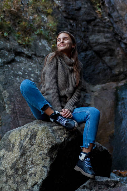 istock Nice Girl traveler at the mistyc waterfall 1220937242