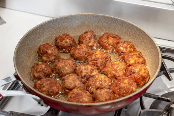 istock Cooking meatballs in oil 1220938322