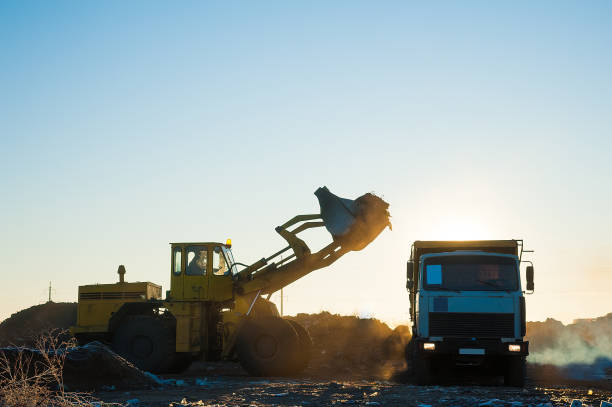 istock Bulldozer removes a wild dump 1220938329