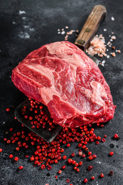 istock Raw Chuck eye roll steak on meat cleaver. Organic beef. Black background. Top view 1220940254