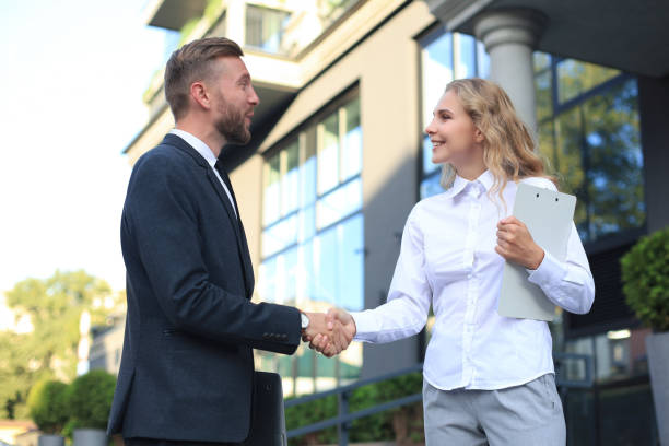 istock Image of collegues discussing documents and shaking hands near office. 1220945861