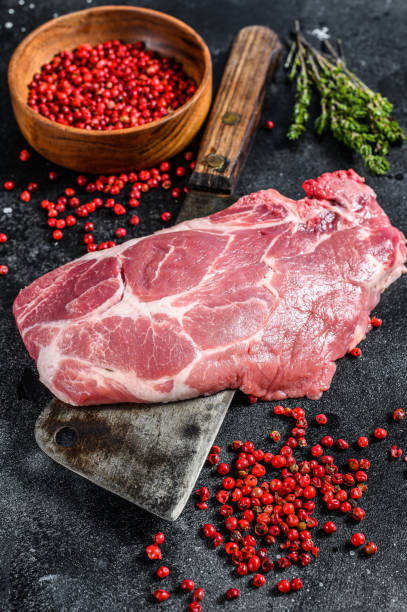 istock Fresh pork meat, marble steak. Black background. Top view 1220948346