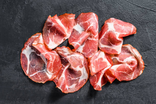 istock Coppa, Capocollo, Capicollo meat.  Black background. Top view 1220949267