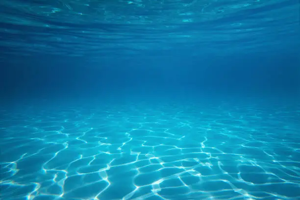 Photo of Underwater empty swimming pool background