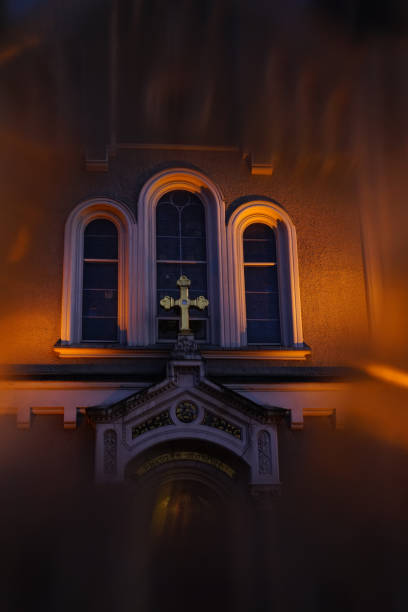 istock Cross on the evening church window, Slovenia 1220953352
