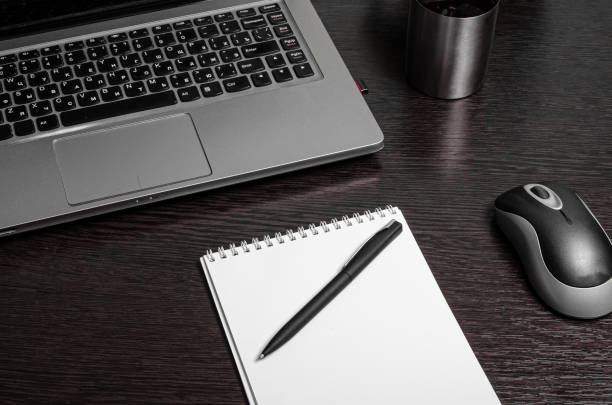 istock laptop notepad pen legs phone home work remotely comfort 1220955731