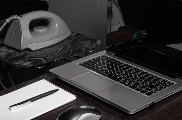 istock workplace at home laptop notebook notepad pen flower iron jacket 1220956191