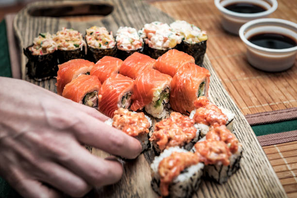 istock the cook places the sushi rolls 1220958194