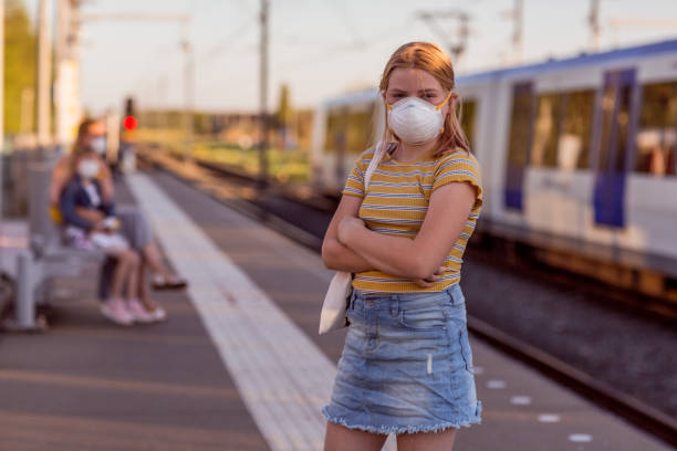 istock Blonde daughter at a train station during virus outbreak 1220958276
