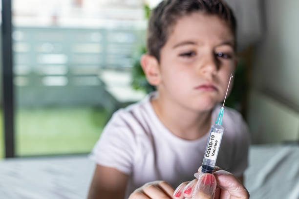 istock Little boy waiting to be vaccinated from Covid-19 1220960136