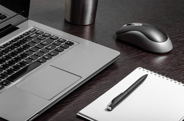 istock laptop notepad pen legs phone home work remotely comfort 1220960166