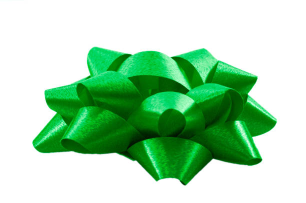 istock Shining anniversary gift and present decorating silky ornament concept green sleek polished glossy bow isolated on white background clipping path cutout 1220964599