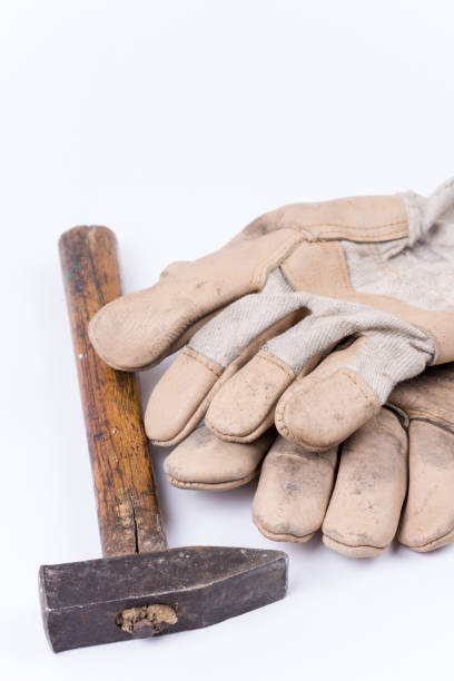 istock Old dirty hammer with used working leather gloves 1220969305